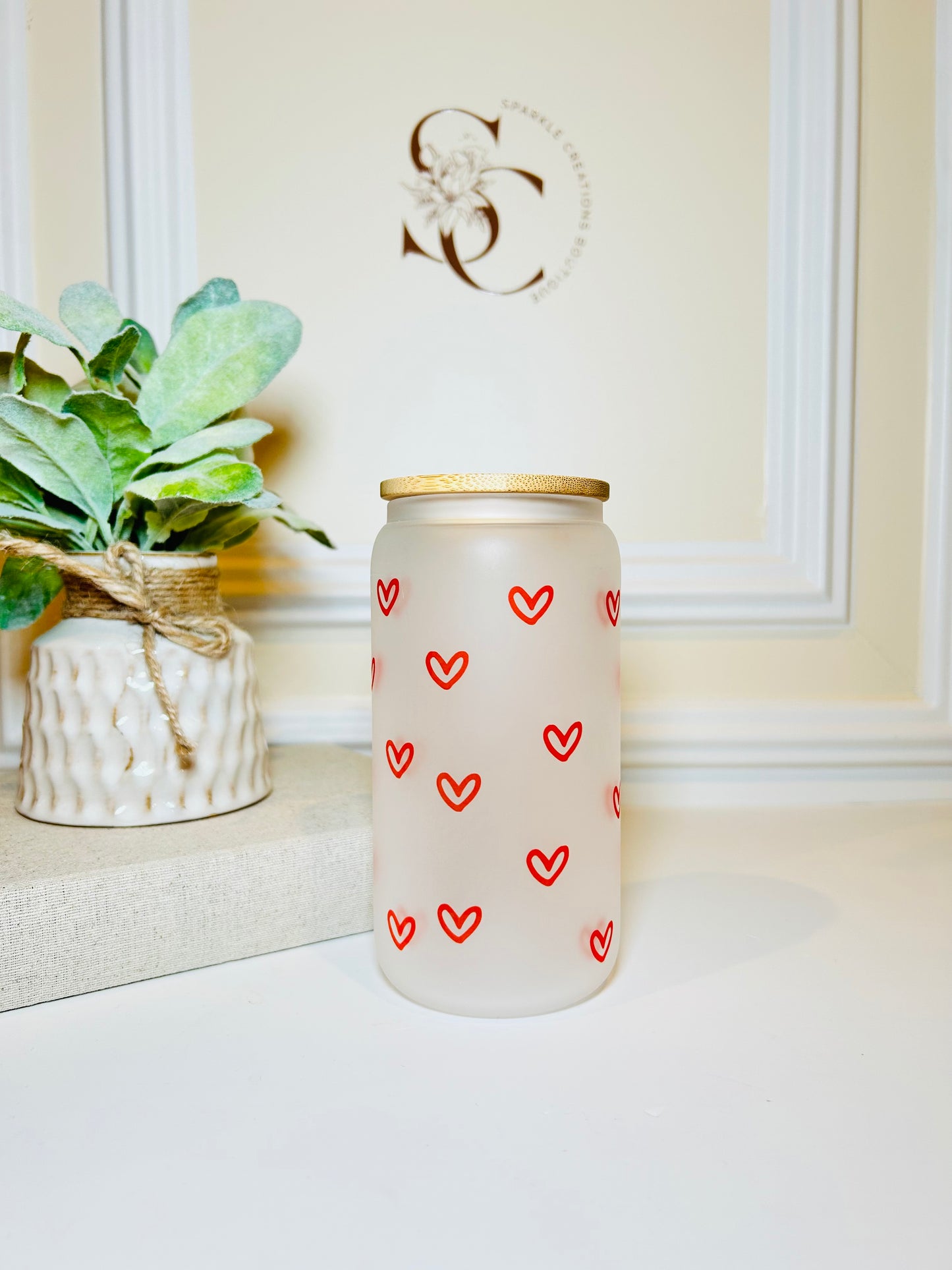 Frosted glass cup with red heart patterns 